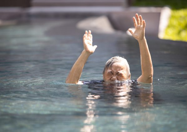 Asian,Senior,People,Struggling,Underwater,,Hand,Peeking,Out,Of,The